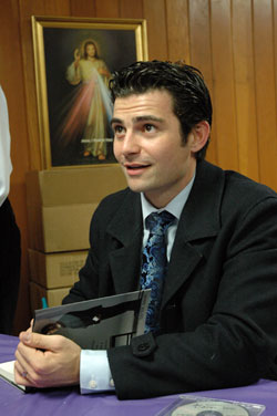 Internationally known author and speaker Tarek Saab of Fort Worth, Texas, signs copies of his book on March 4 at Our Lady of the Most Holy Rosary Parish in Indianapolis. Saab spoke to a capacity crowd attending the parish’s “Spaghetti and Spirituality” Lenten adult education program. He is the co-founder of Lionheart Apparel, a Christian clothing company, and president of T. Saab Media Inc. (Photo by Mary Ann Wyand) 