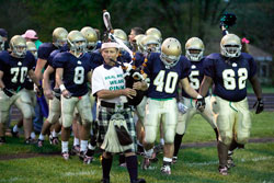 Cathedral High School football players run on to the field before their Oct. 23 game against Lebanon High School wearing pink shoelaces. The shoelaces were a symbolic gesture to support fellow student Alyssa O’Malia’s effort to raise funds and awareness about breast cancer, the disease that her mother, Debi, is battling. (Submitted photo) 