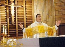 Father Thomas Schliessmann prays the eucharistic prayer during a Nov. 18 Mass at St. Rose of Lima Church in Franklin, where he serves as the pastor. He also is the pastor of Holy Trinity Parish in Edinburgh. (Photo by Sean Gallagher)