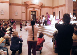 Parents and family members of Scouts being honored from Our Lady of the Greenwood Parish in Greenwood snap photos as Bishop Gerald A. Gettelfinger greets the Scouts. (Photo by Brandon A. Evans)