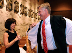 Gail and Brett Pheffer exchange looks of joy while Brett puts on a baptismal garment on April 3 during the Easter Vigil Mass at St. Luke the Evangelist Church in Indianapolis. Just minutes earlier, Brett had been baptized. Gail, his wife of 25 years, was his sponsor. (Submitted photo by Walt Kuhn)