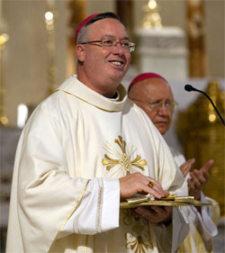 Bishop Christopher J. Coyne, apostolic administrator of the Archdiocese of Indianapolis, addresses attendees at the Catholic Media Conference during Mass at St. John the Evangelist Church in Indianapolis June 20. Members of the Catholic press and media g roups were holding their annual convention. At right is Archbishop Claudio Celli, president of the Pontifical Council for Social Communications. (CNS photo/Nancy Wiechec)