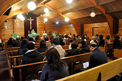 Members of the Korean Catholic Community in Indianapolis sing a hymn while Father Jiho Peter Son prepares the altar during Mass at Korean Catholic Community Church of Our Lady of the Holy Rosary in Indianapolis on Jan. 18. (Photos by Natalie Hoefer)