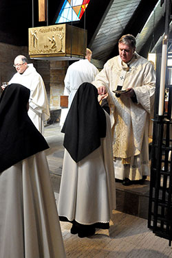 A Discalced Carmelite nun receives Communion from Archbishop Joseph W. Tobin during Mass on Oct. 10. (Photos by Sean Gallagher)