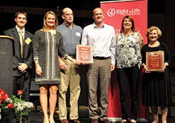 Marc Tuttle, director of Right to Life of Indianapolis, left, poses with Charles E. Stimming, Sr., Pro-Life Award recipient Marilyn Schneider, far right, and the children of the second recipient, Mary Kay Overbeck, during the Celebrate Life Dinner at the Indiana Convention Center in Indianapolis on Oct. 4. Receiving the honor on behalf of their mother are Kassy McPherson, second from left, Scott Overbeck, Dan Overbeck and Mary Lynn Lesnick. (Photos by Natalie Hoefer)