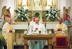 Father Wilfred “Sonny” Day celebrates Mass on May 5 at St. John the Baptist Church in Starlight to mark the 50th anniversary of his ordination to the priesthood. Concelebrating the Mass are retired Msgr. Paul Richart, left, Father Eric Johnson and Father Thomas Clegg. Father Day is pastor of St. John the Baptist Parish in Starlight and dean of the New Albany Deanery. (Submitted photo by Paul Bierman)