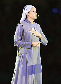 Society of Our Lady of the Most Holy Trinity Sister Miriam James Heidland addresses NCYC participants during the Nov. 17 morning session at Lucas Oil Stadium in Indianapolis. (Photo by Bob Nichols)