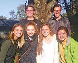 In Bloomington, a few of the Never Alone: Ministry to the Elderly (NAME) volunteers of St. Paul Catholic Center’s campus ministry, serving the students of Indiana University, pose outside of the Golden LivingCenter where they visit the elderly once a week. The volunteers are, front row: Zoey Fields, left, Corinne Maue, Rileigh Johnson and Yahilin Vera; back row: Matthew Neuman, left, and Matthew Peisen. (Submitted photo)