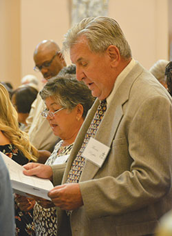 Barbara and Thomas Rzepka of St. Gabriel the Archangel Parish in Indianapolis sing during the annual archdiocesan Golden Wedding Anniversary Mass at SS. Peter and Paul Cathedral in Indianapolis on Aug. 25. They were among the 68 couples from 37 parishes throughout central and southern Indiana who worshipped at the Mass to celebrate their 50th anniversary. (Photo by Natalie Hoefer)