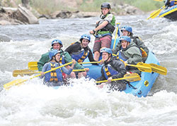 Archdiocesan high school students experience the adrenaline of rushing through white-water rapids—one of the many adventures during the annual Summer Field Study program led by Joseph Hollowell, president of Roncalli High School in Indianapolis, for nearly 40 years. (Submitted photo)