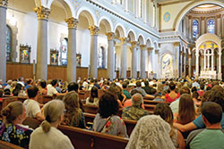 The congregation listens in St. Joan of Arc Church in Indianapolis as former pastor Guy Roberts delivers the homily for the parish’s 100th anniversary celebration Mass on July 17. (Photo by Natalie Hoefer)