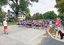 Father Robert Sims leads a prayer before a race that kicks off the parish festival at Immaculate Heart of Mary Parish in Indianapolis where he is the pastor. (Submitted photo)