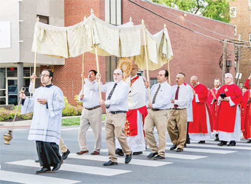 Father Michael Keucher, archdiocesan vocations director and spiritual advisor of the local Catholic Charismatic Renewal apostolic movement, processes with the Eucharist from SS. Peter and Paul Cathedral in Indianapolis to the Archbishop Edward T. O’Meara Catholic Center after a Pentecost liturgy on May 18. (Submitted photo)