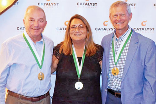 Tracy Cooper, left, Leisa Roll and Bob Naville show their joy in receiving the St. John Bosco Medal, the highest honor that the archdiocese’s Catholic Youth Organization awards its volunteers. (Submitted photo)