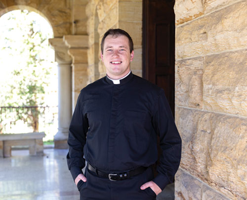 Seminarian Samuel Hansen poses on Oct. 3 by the main entrance of Saint Meinrad Seminary and School of Theology in St. Meinrad. A member of St. Roch Parish in Indianapolis, Hansen is in his fourth year of priestly formation as an archdiocesan seminarian. (Photos courtesy of Saint Meinrad Archabbey)