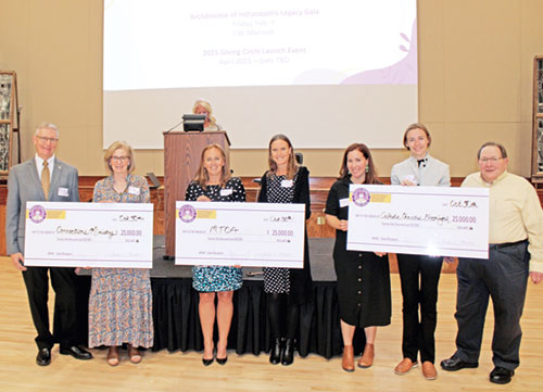 Representatives of the inaugural Catholic Women’s Giving Circle (CWGC) grant-winning archdiocesan agencies and CWGC members pose on Oct. 30 during an awards dinner at the Archbishop Edward T. O’Meara Catholic Center in Indianapolis. They are, from left, Deacon John Cord, coordinator of the archdiocese’s Corrections Ministry; Kathy Laudick of CWGC; Lora Prange and Kacy Naab of Mother Theodore Catholic Academies; Elisabeth Williams of CWGC; and Emily Cook and Dennis Craig of Catholic Charities in Bloomington. (Photos by Jennifer Lindberg) 